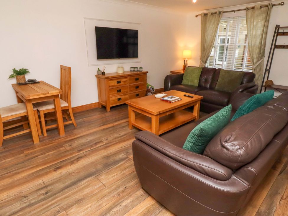 A living room with a television and furniture at 1 Pear Tree Beadnell