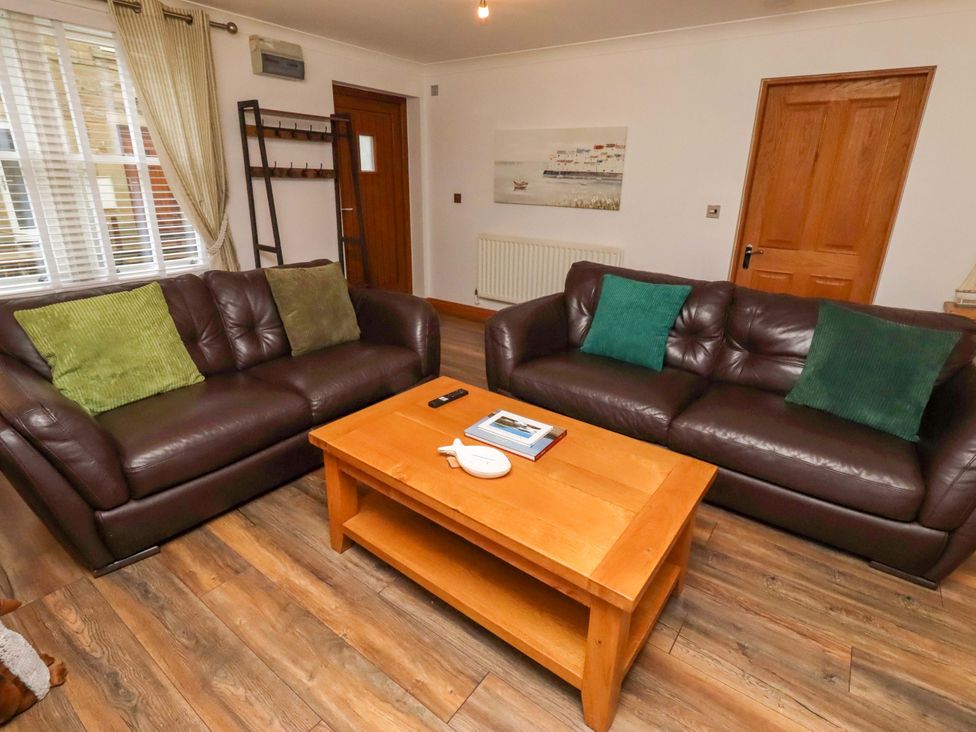 A living room with sofas and a coffee table at 1 Pear Tree in Beadnell