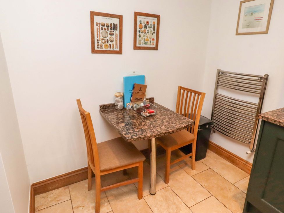 A dining area with a table and chairs at 1 Pear Tree Beadnell