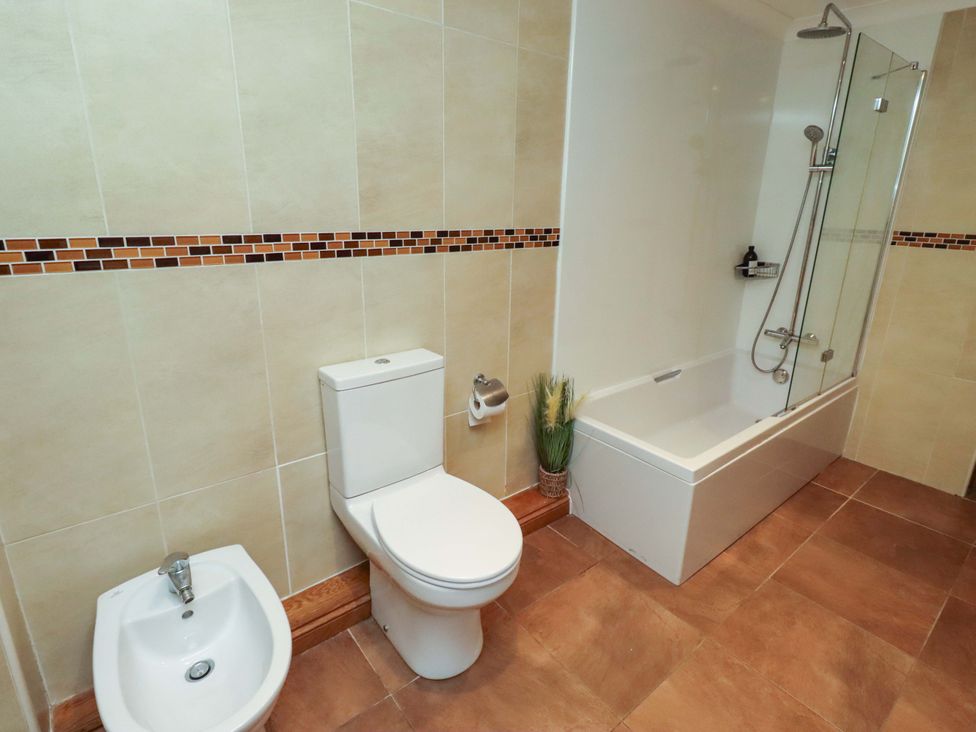 A bathroom with a toilet bidet and bathtub at 1 Pear Tree in Beadnell