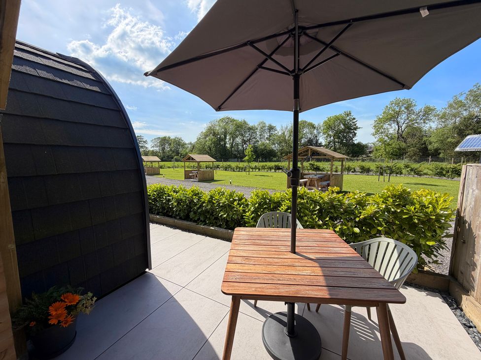 An outdoor area with a wooden table and chairs at Oh Deer in Ashbourne