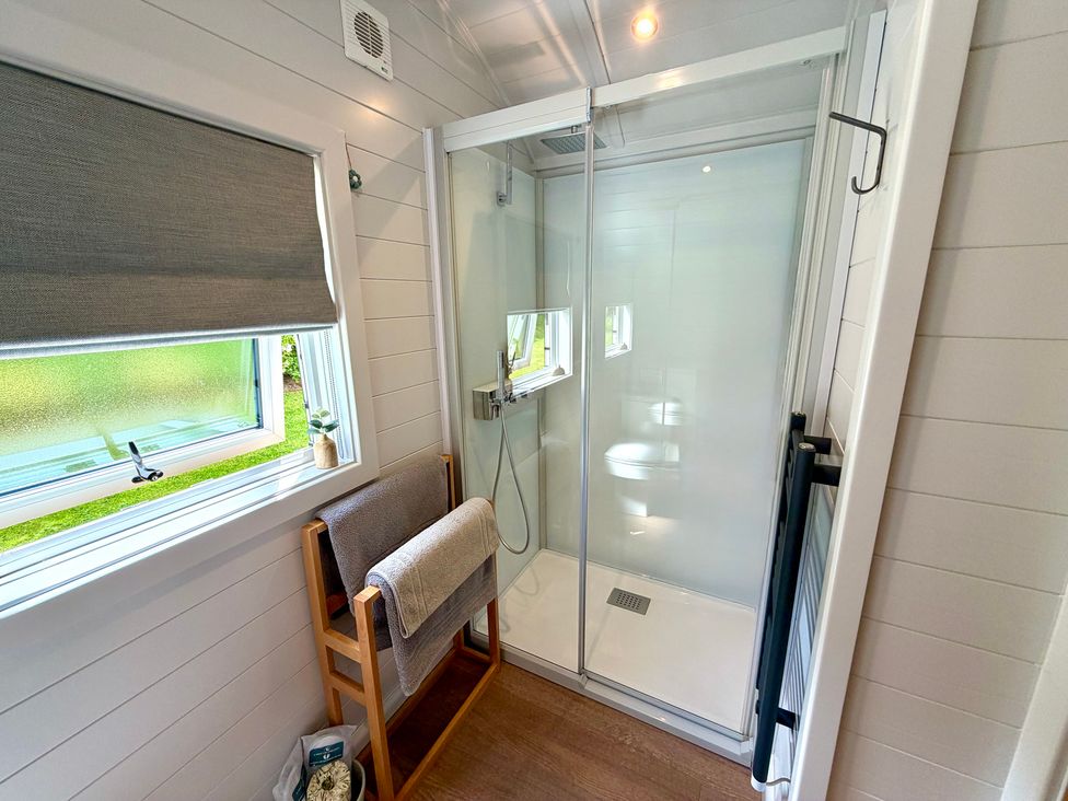 A bathroom with a shower and towel rack at Oh Deer in Ashbourne