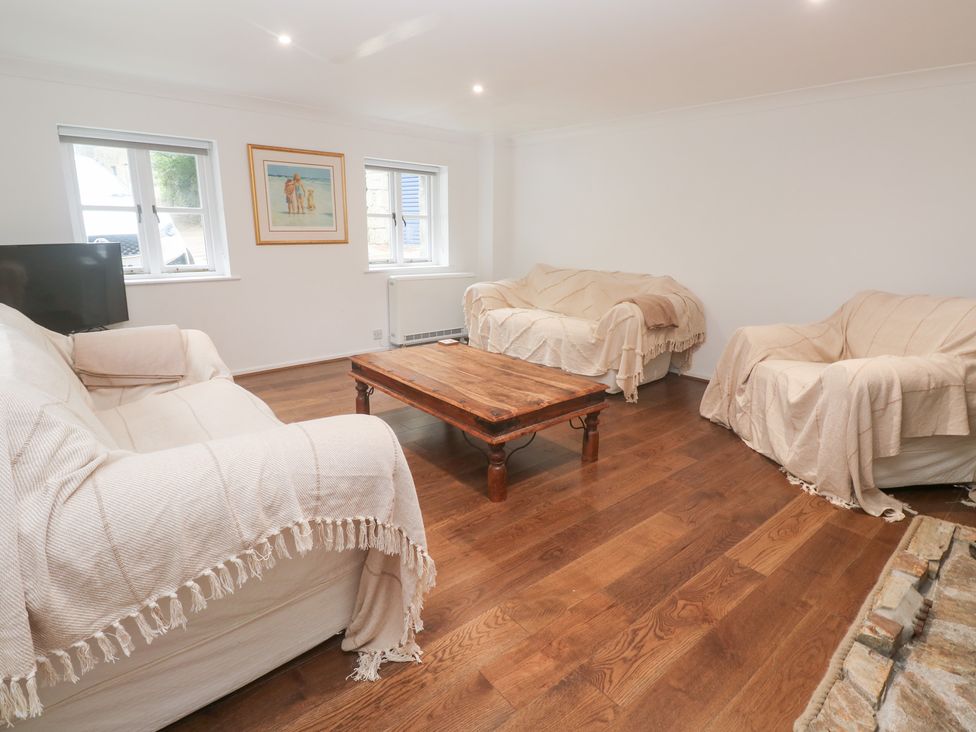 A living room with couches and a coffee table at Sunnyvale Cottage in Rosudgeon