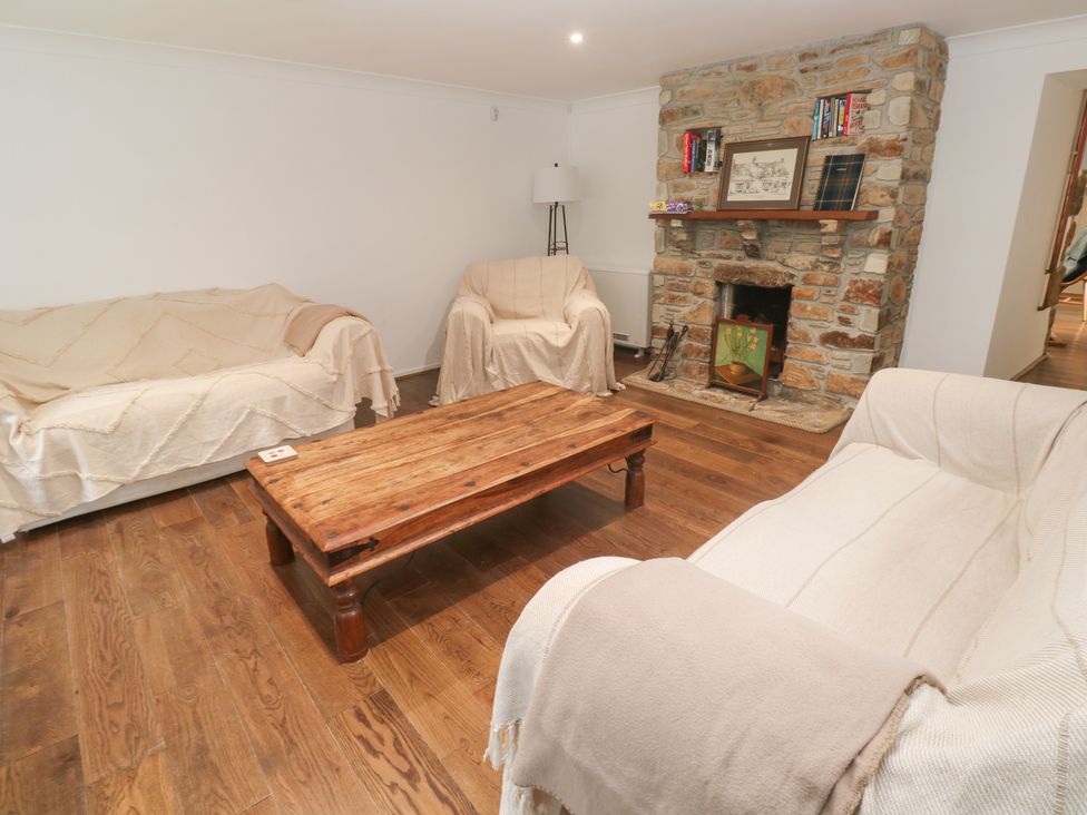 A living room with sofas and a coffee table at Sunnyvale Cottage in Rosudgeon