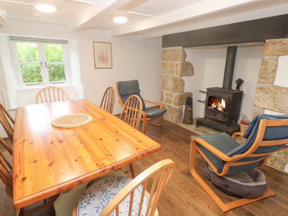 A dining room with a table and chairs at Sunnyvale Cottage in Rosudgeon