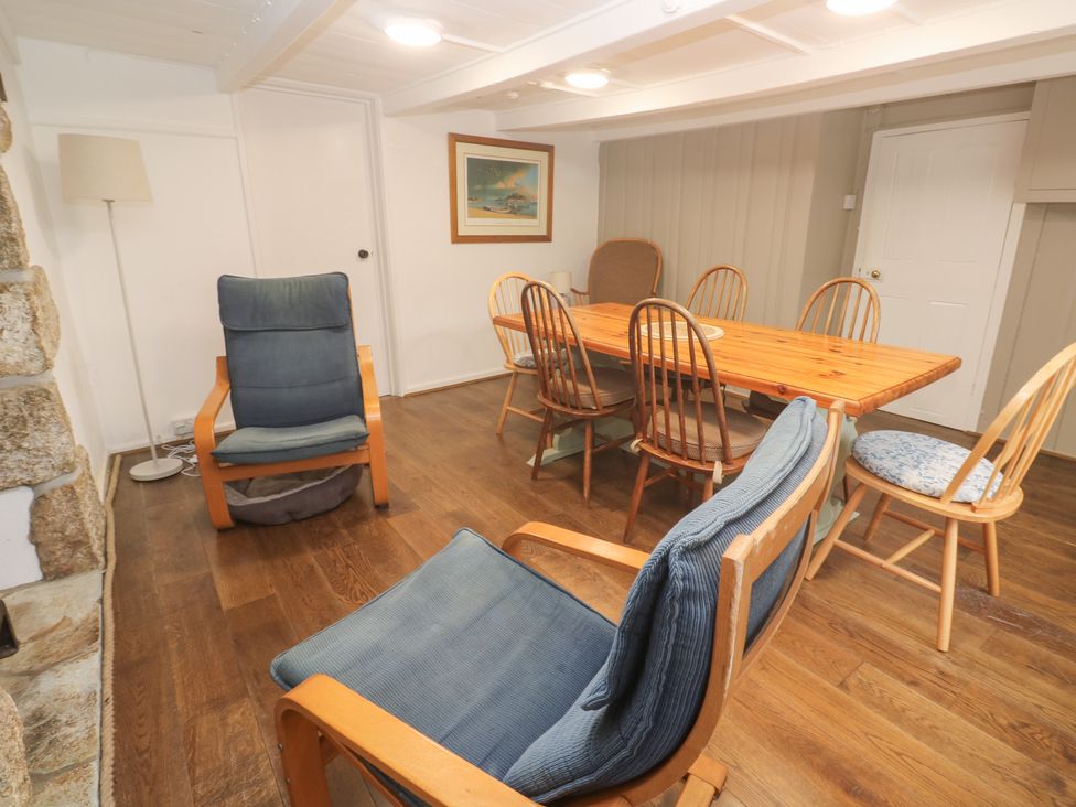A dining room with a table and chairs at Sunnyvale Cottage in Rosudgeon