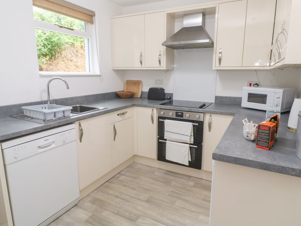 A kitchen with various appliances and cabinets at Sunnyvale Cottage Rosudgeon