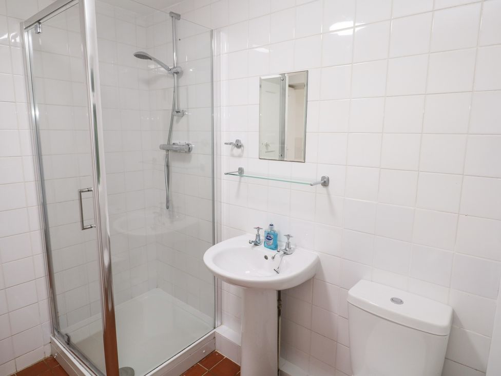 A bathroom with a shower, sink and toilet at Sunnyvale Cottage in Rosudgeon