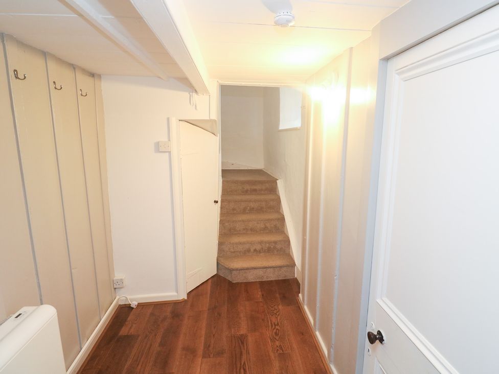 A hallway with stairs and a door at Sunnyvale Cottage in Rosudgeon