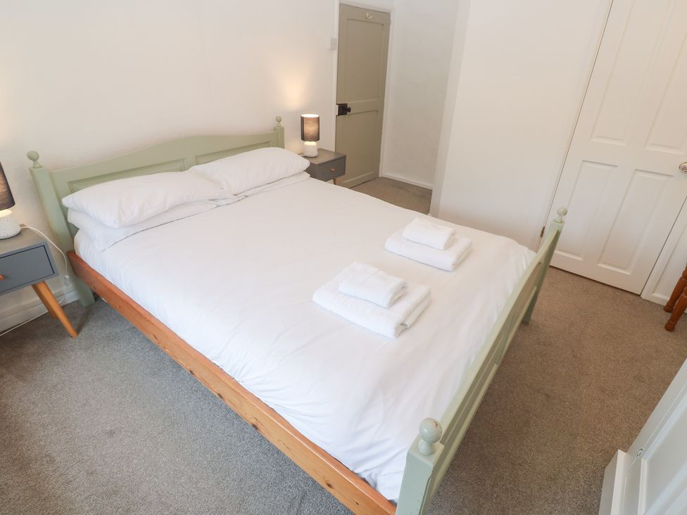 A bedroom with a double bed and nightstand at Sunnyvale Cottage Rosudgeon