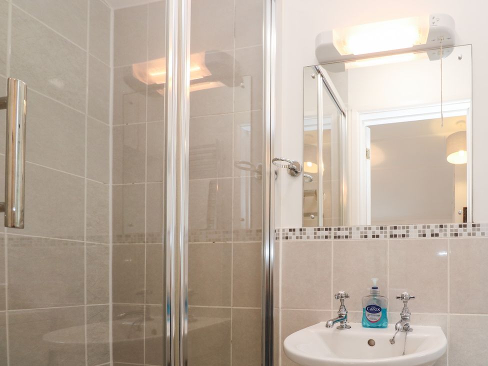 A bathroom with a shower and sink at Sunnyvale Cottage in Rosudgeon