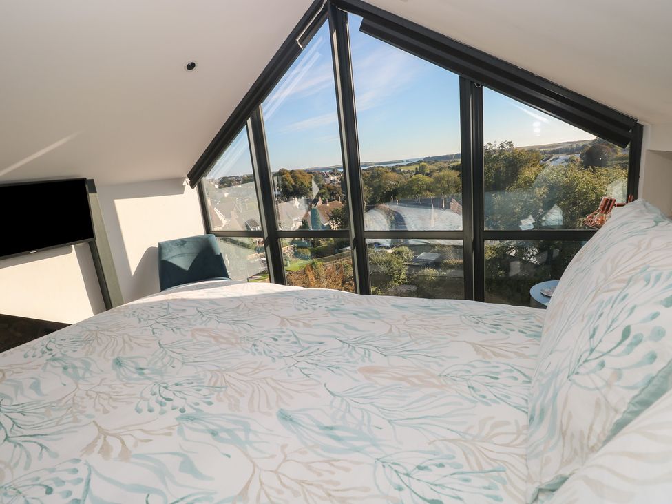 A bedroom with a window view and a bed at 11 Brython Place Tenby