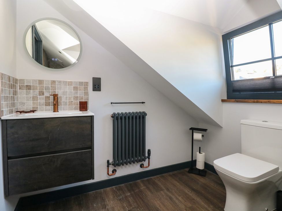 A bathroom with a wash basin and toilet at 11 Brython Place Tenby