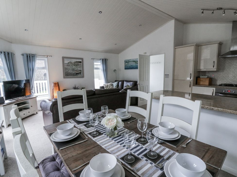 A dining room with a table set for dinner at Seacroft in Stepaside near Kilgetty