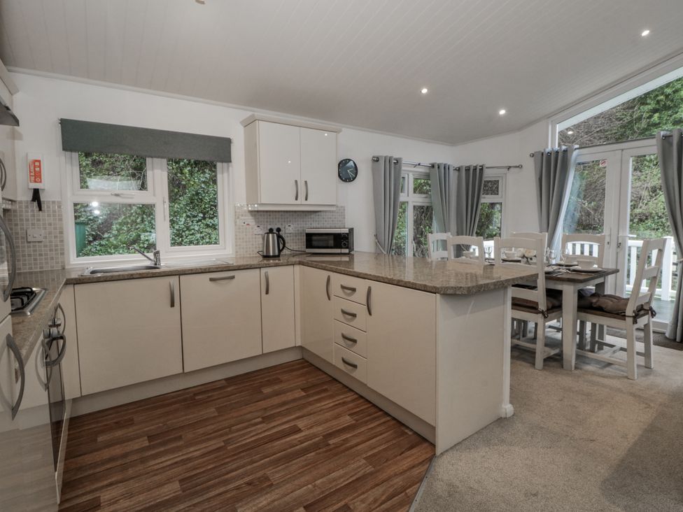 A kitchen with countertop and dining area at Seacroft in Stepaside near Kilgetty