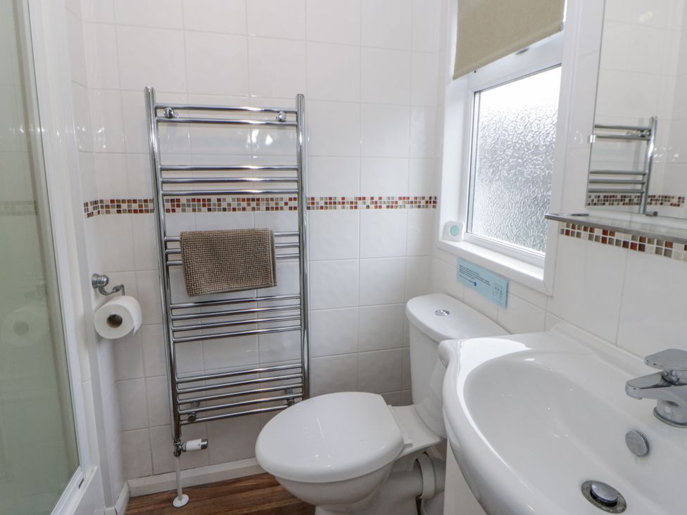 A bathroom with toilet and sink at Seacroft in Stepaside near Kilgetty