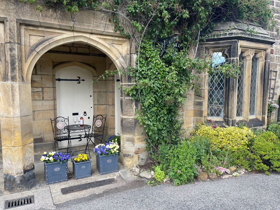 An outdoor seating area with a table and chairs at The Ticket Office in Ruswarp near Whitby