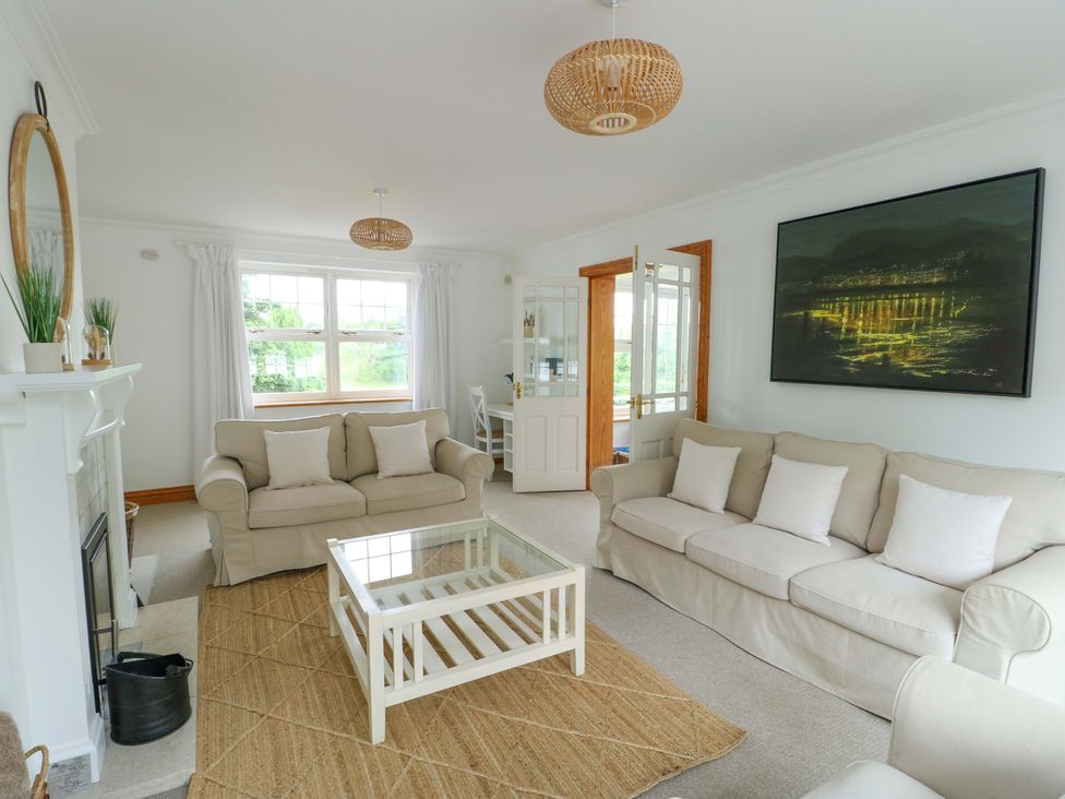 A living room with a sofa and coffee table at Bwthyn Clai in Llangefni