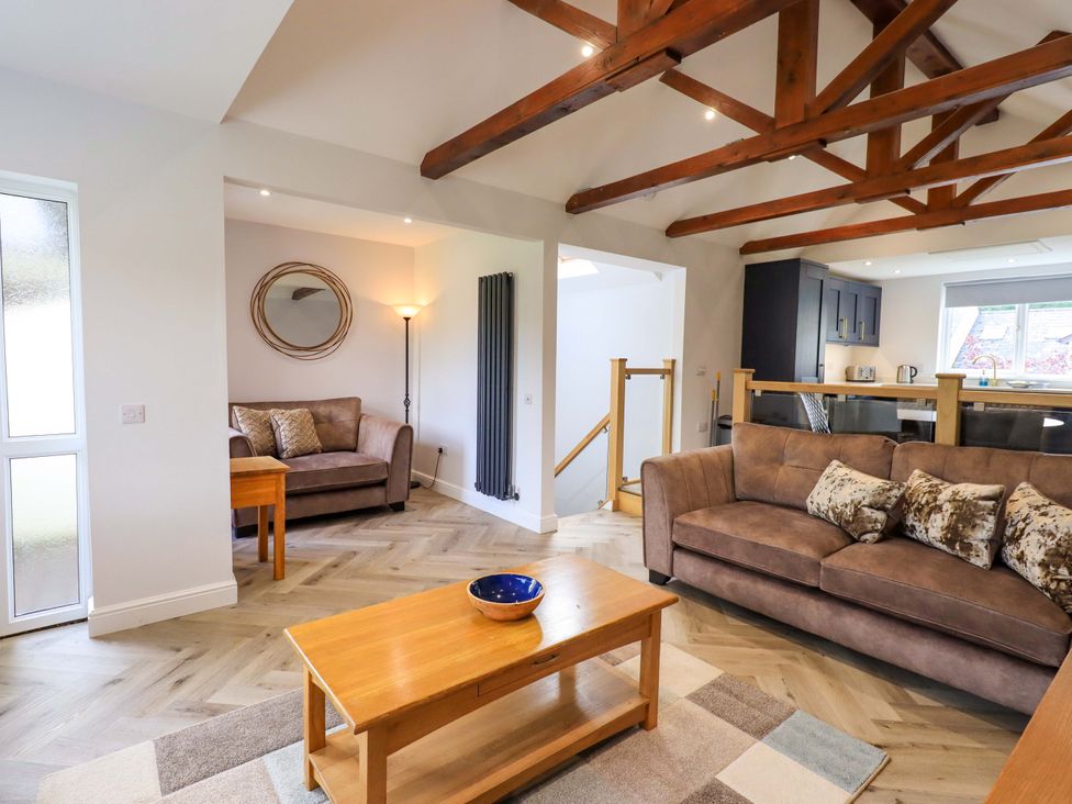 A living room with a sofa and a coffee table at Mallard Cottage in Penrith
