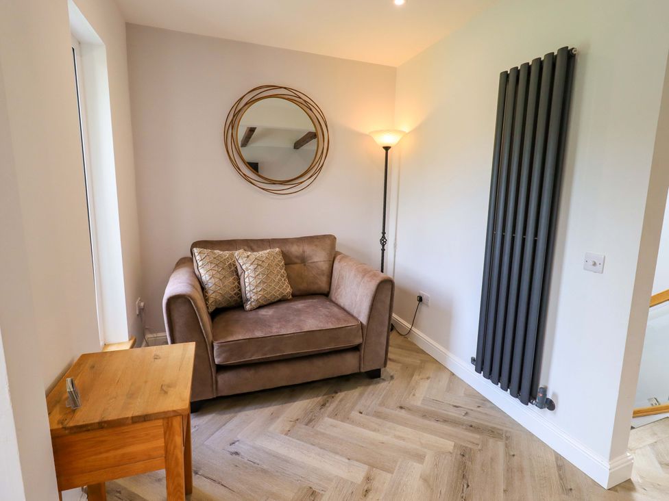 A living room with a sofa and coffee table at Mallard Cottage in Penrith