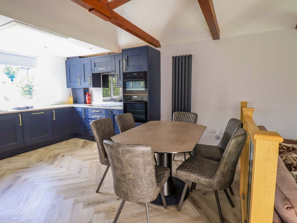 A kitchen with a dining table and chairs at Mallard Cottage in Penrith
