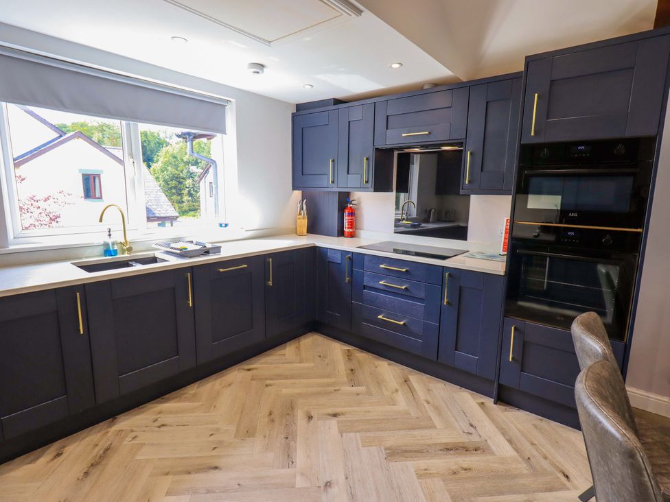 A kitchen with cabinets and appliances at Mallard Cottage Penrith