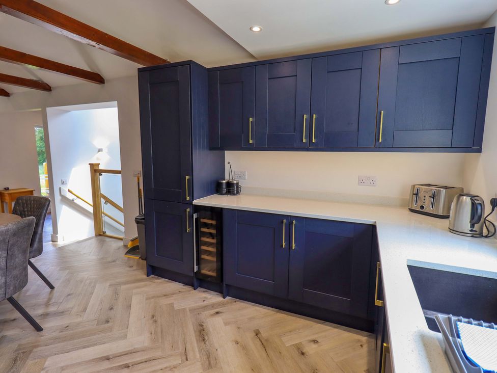 A kitchen with cabinets and appliances at Mallard Cottage in Penrith