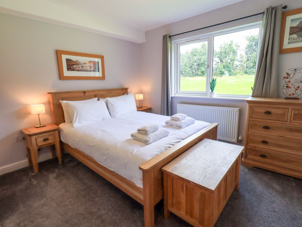 A bedroom with a double bed and nightstands at Mallard Cottage Penrith