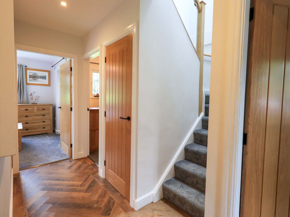 A hallway with stairs and a dresser at Mallard Cottage Penrith