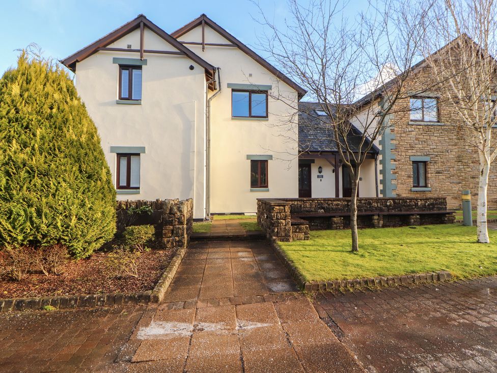 A house with windows and a door along a pathway at Mallard Cottage in Penrith