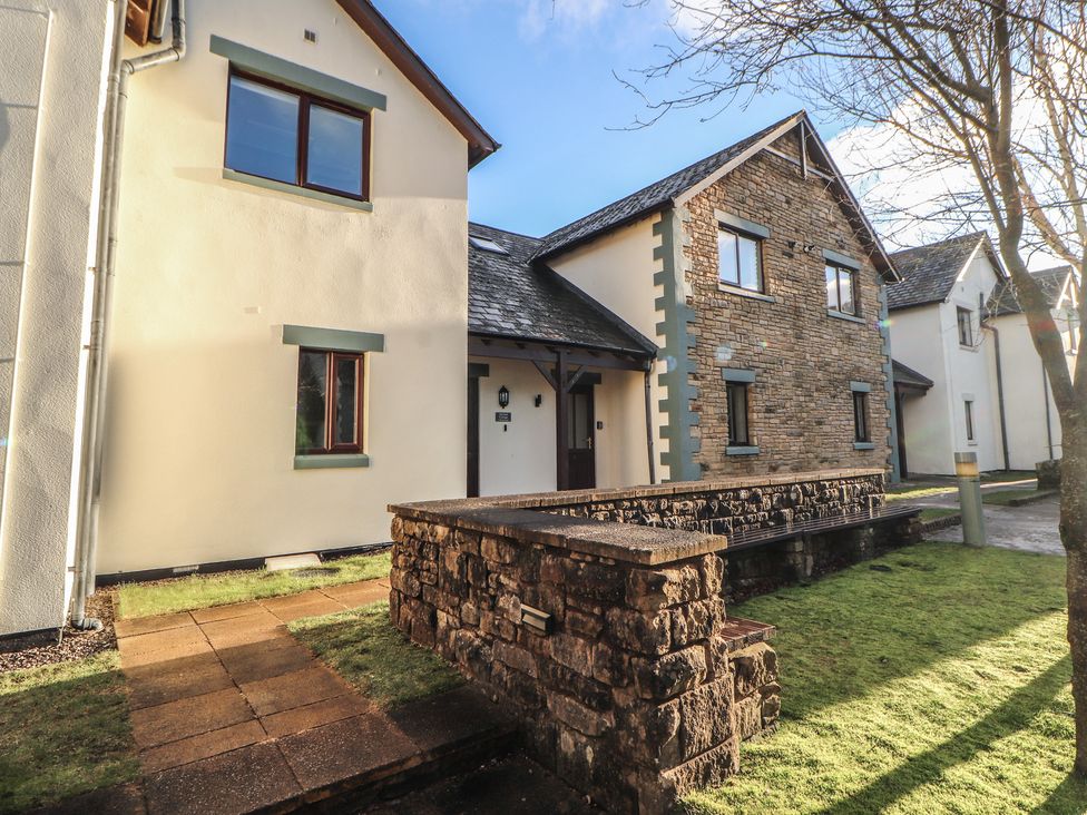 A house exterior with a stone wall and pathway at Mallard Cottage Penrith