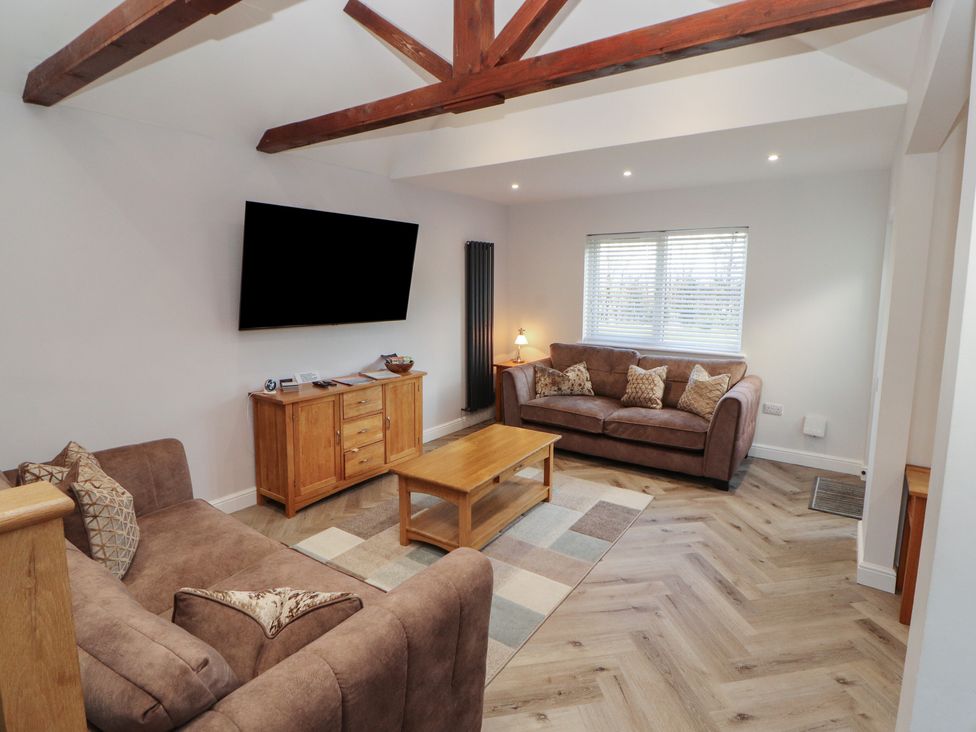 A living room with sofas and a coffee table at Mallard Cottage in Penrith