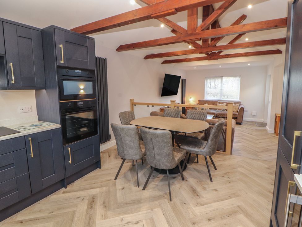 A kitchen with dining area at Mallard Cottage in Penrith