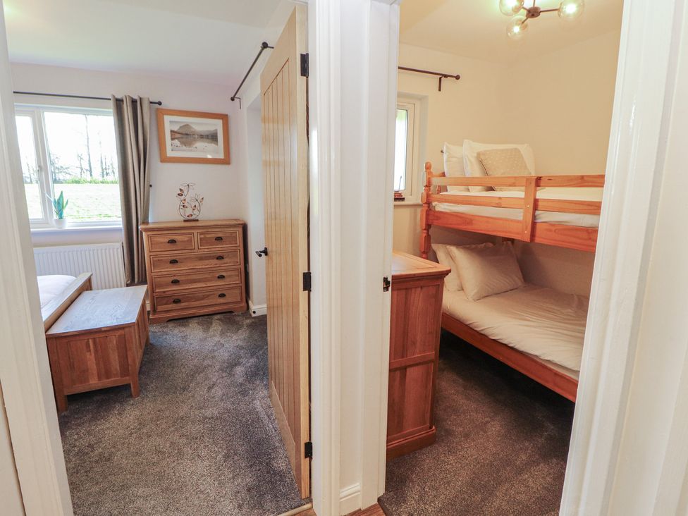 A bedroom with a bunk bed and a chest of drawers at Mallard Cottage Penrith