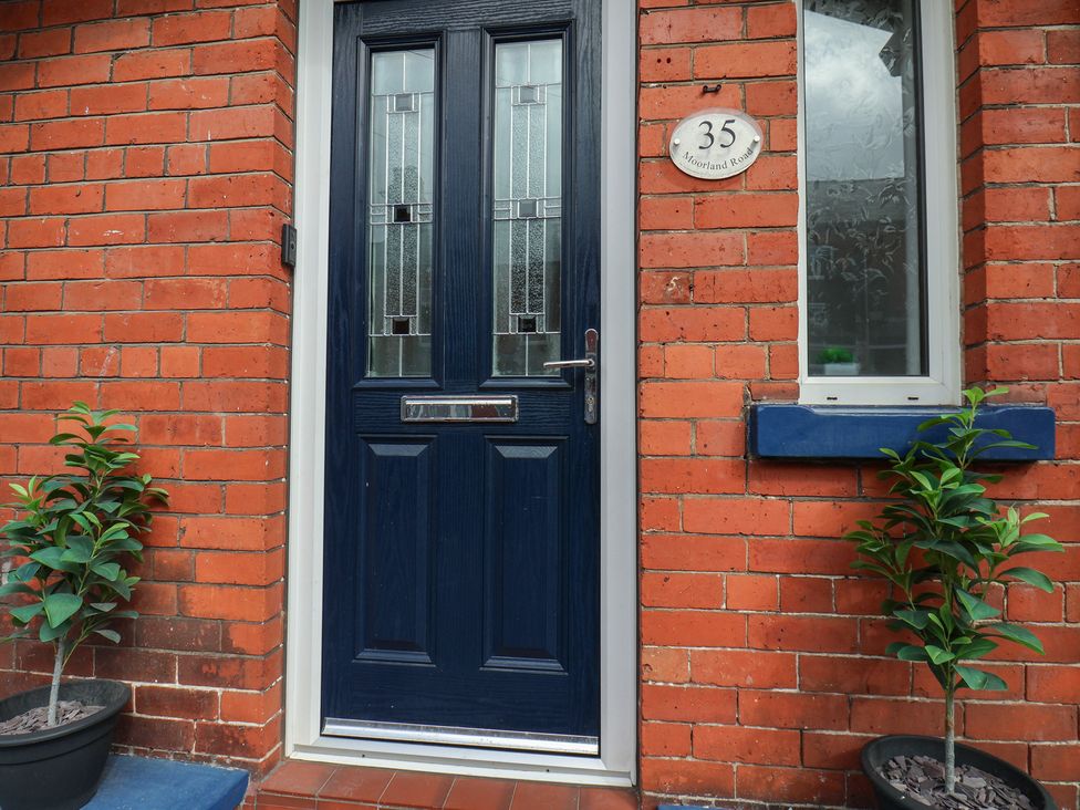 An entrance with a blue door and a plant at 35 Moorland Road Scarborough