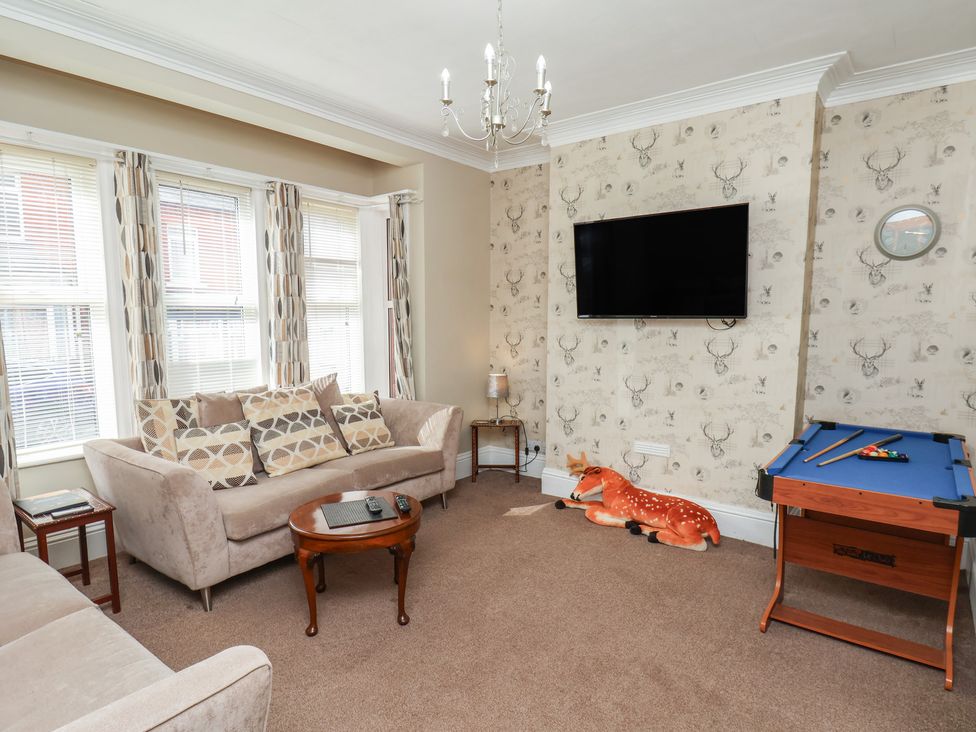 A living room with a sofa and a television at 35 Moorland Road in Scarborough