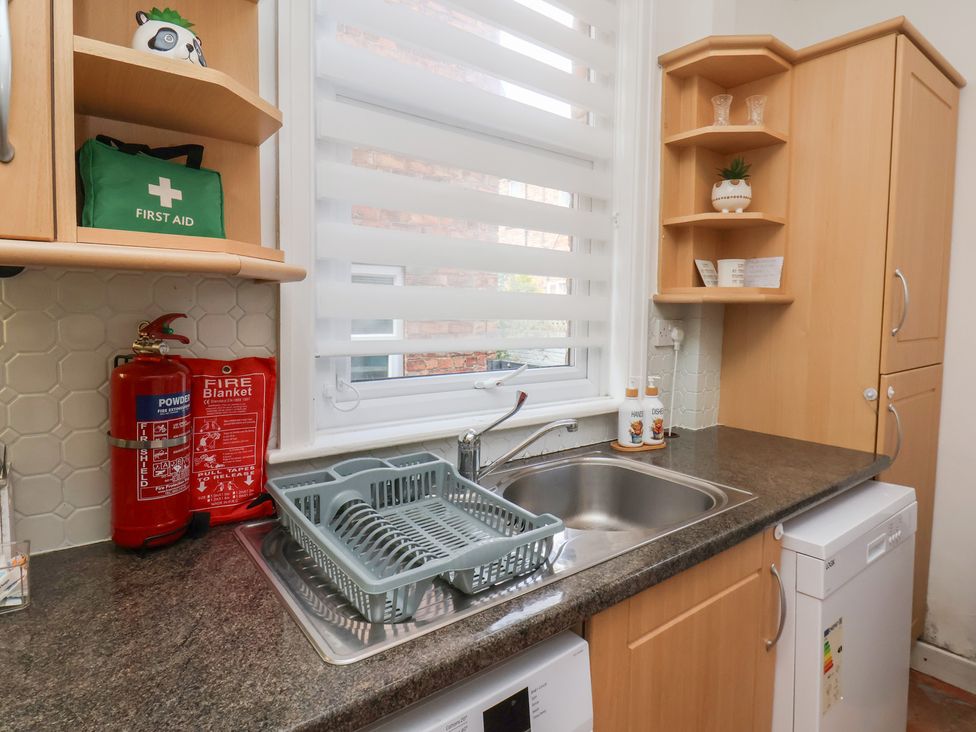 A kitchen with a sink and cabinets at 35 Moorland Road Scarborough