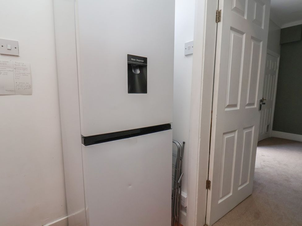 A fridge next to a door in the kitchen at 35 Moorland Road Scarborough