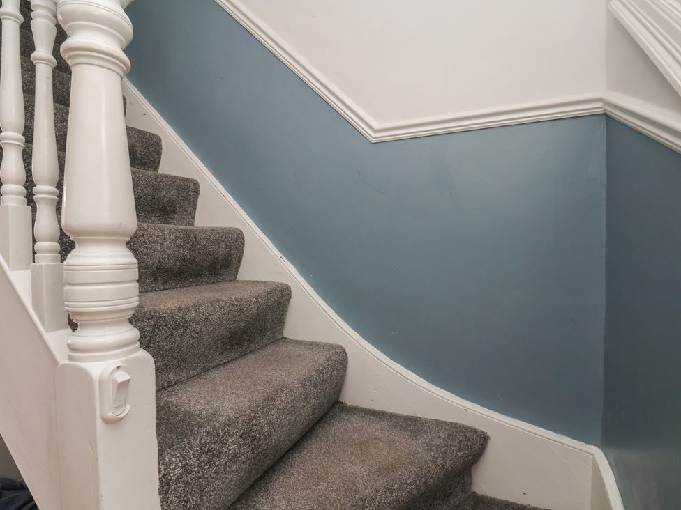 A staircase with carpet and a painted wall at 35 Moorland Road Scarborough