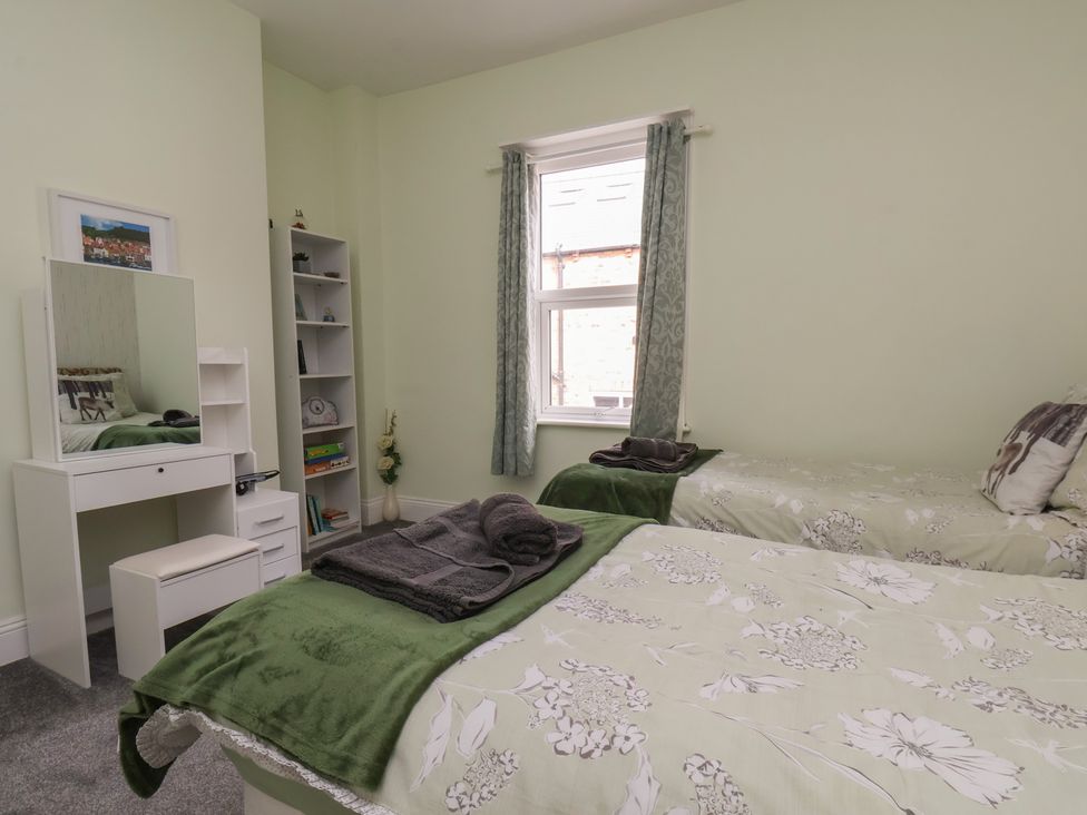 A bedroom with twin beds and a dresser at 35 Moorland Road, Scarborough