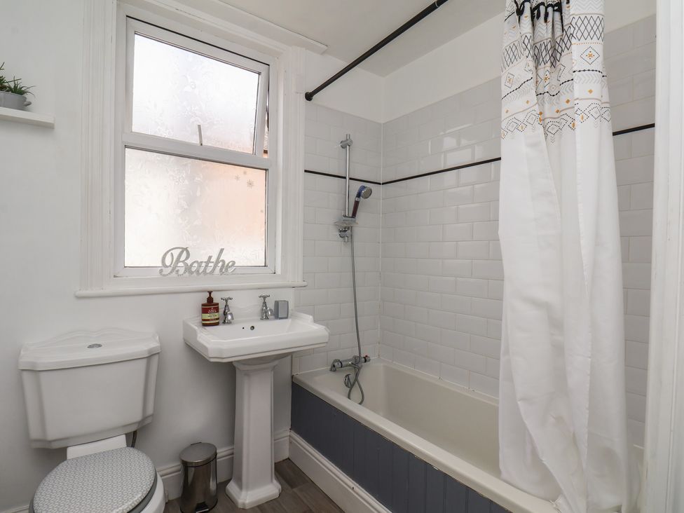 A bathroom with a bathtub, sink, and toilet at 35 Moorland Road, Scarborough