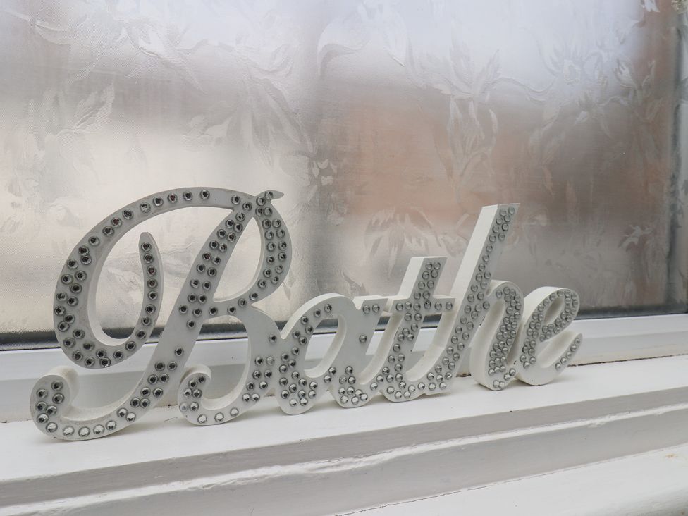 A decorative sign that says Bathe on a windowsill at 35 Moorland Road, Scarborough
