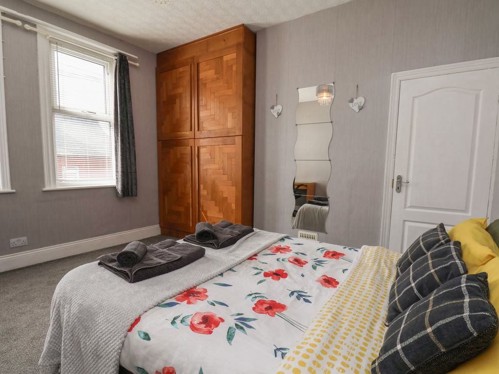 A bedroom with a bed and wardrobe at 35 Moorland Road Scarborough