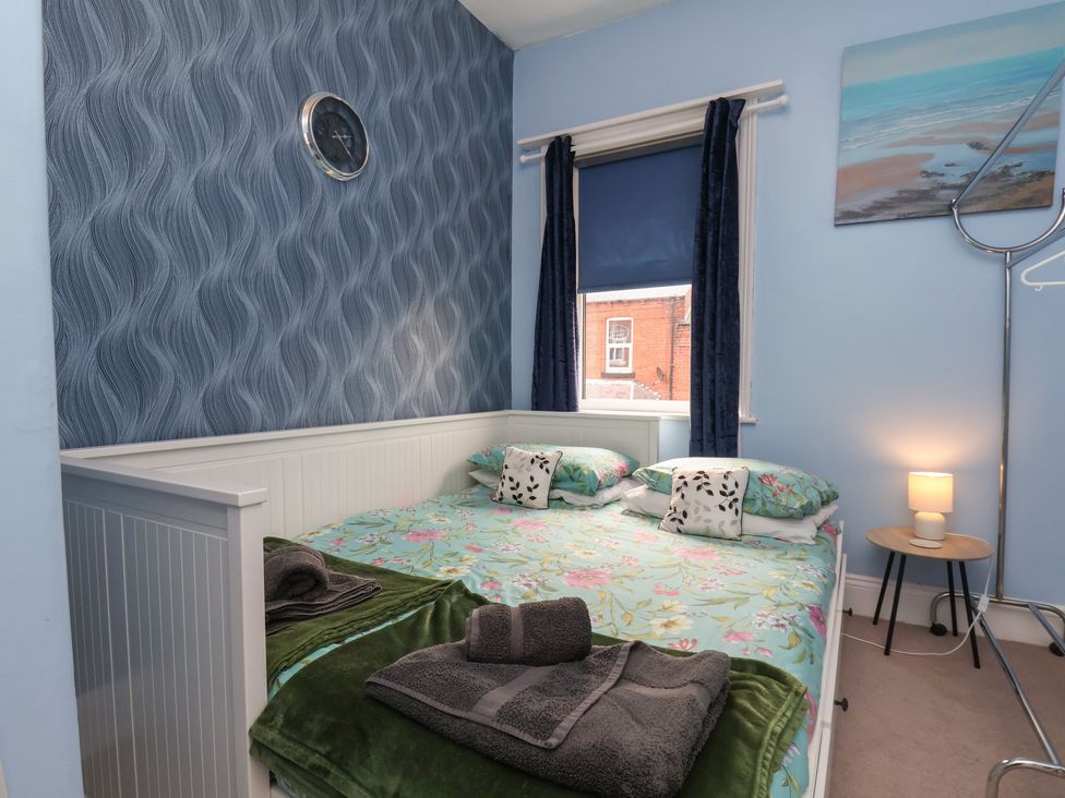 A bedroom with a bed and bedside table at 35 Moorland Road in Scarborough