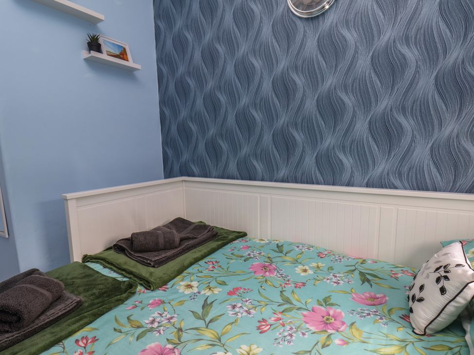 A bedroom with a bed and wall decorations at 35 Moorland Road Scarborough