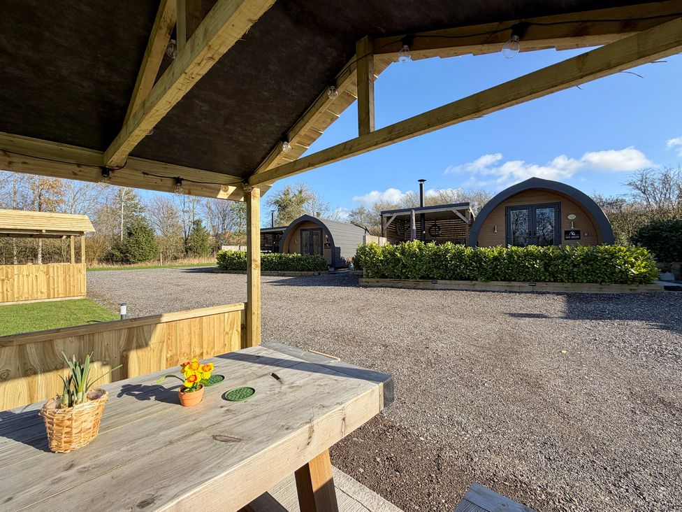 An outdoor area with huts and a table at No Deer in Ashbourne