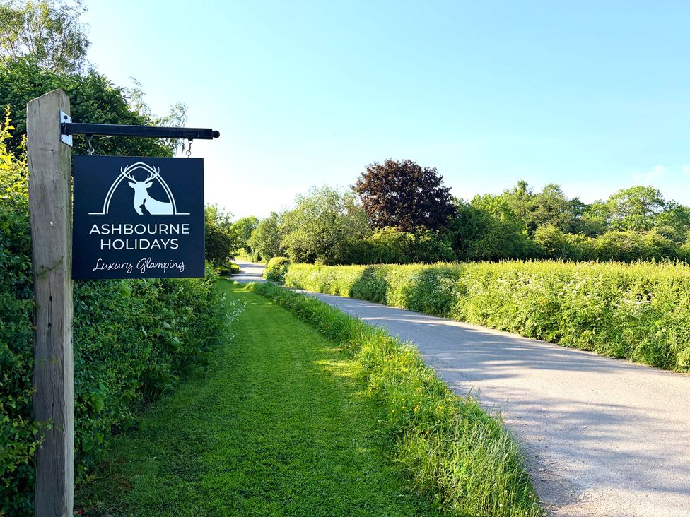 A sign for Ashbourne Holidays near the road in Ashbourne