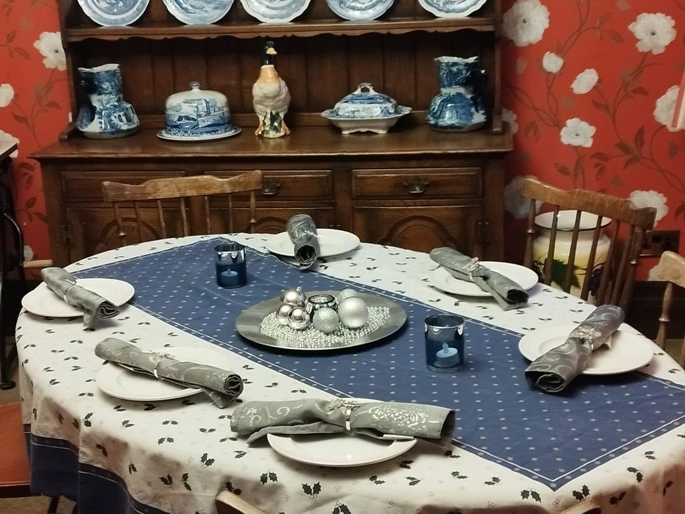 A dining table set with plates and napkins at Highcliffe Manor in Flamborough