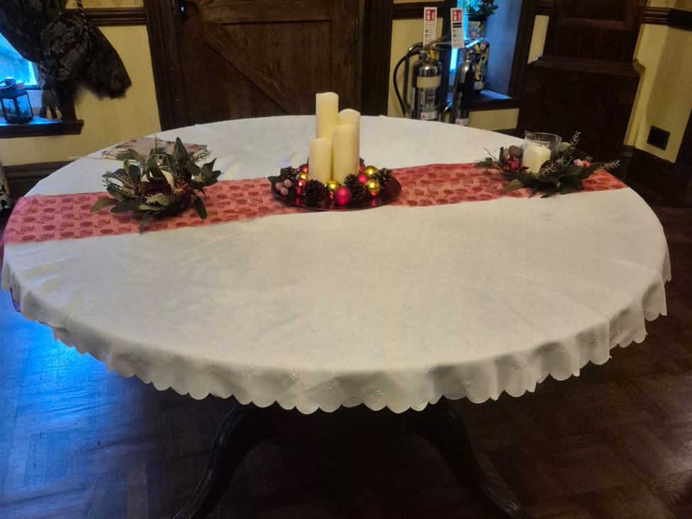 A round table with a decorative centerpiece and candles at Highcliffe Manor in Flamborough