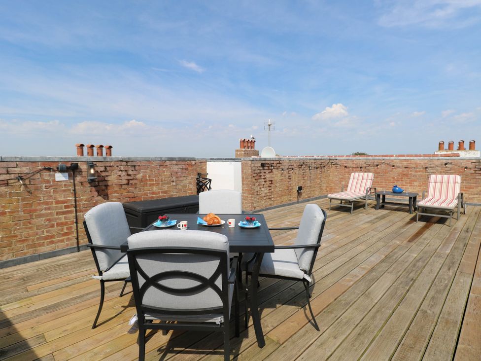 A roof terrace with table and chairs at Skylark in Southwold